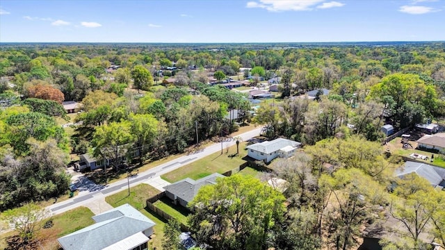 birds eye view of property with a forest view