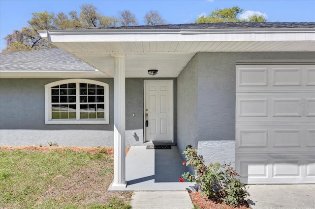 property entrance with stucco siding and a shingled roof