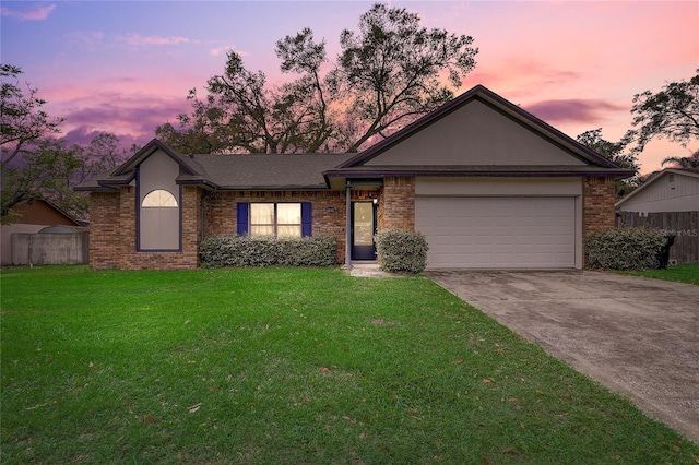 single story home featuring a lawn, brick siding, and fence