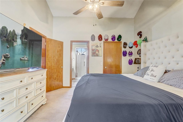 bedroom featuring a ceiling fan, light colored carpet, and baseboards