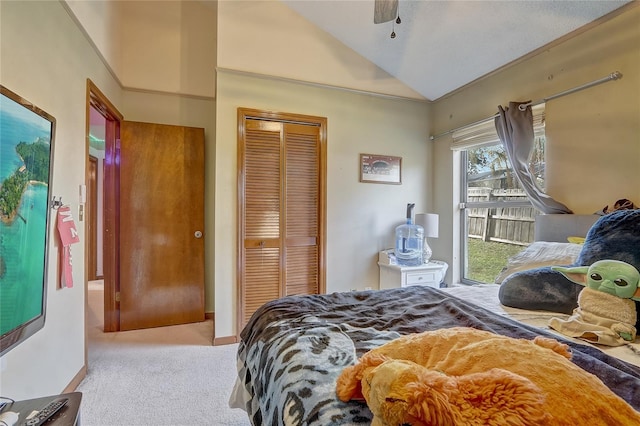 bedroom with a ceiling fan, a closet, carpet flooring, baseboards, and vaulted ceiling