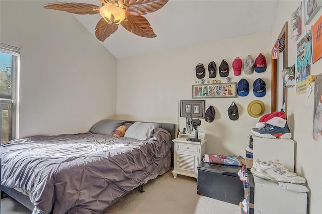 bedroom featuring lofted ceiling, a ceiling fan, and light carpet