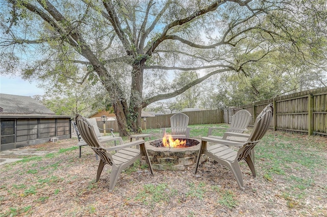 view of yard featuring an outdoor fire pit and a fenced backyard