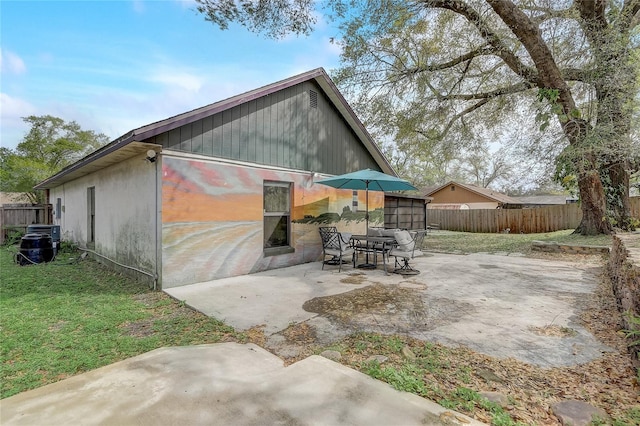 exterior space featuring a lawn, a patio, and fence