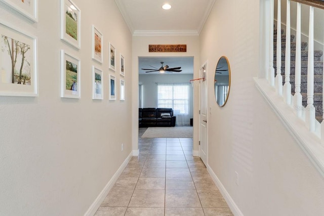 corridor featuring light tile patterned floors, baseboards, recessed lighting, stairs, and crown molding