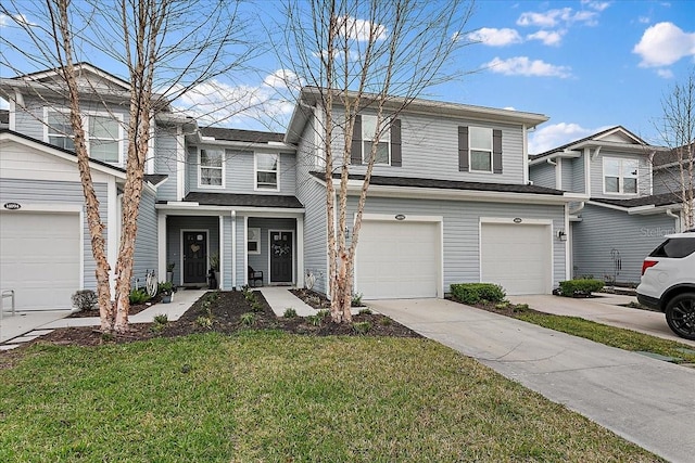 view of front of house featuring a front lawn, an attached garage, and driveway