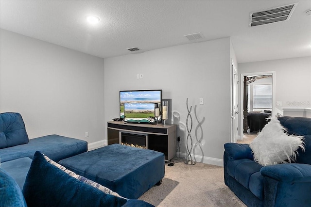 living room featuring light carpet, visible vents, and baseboards