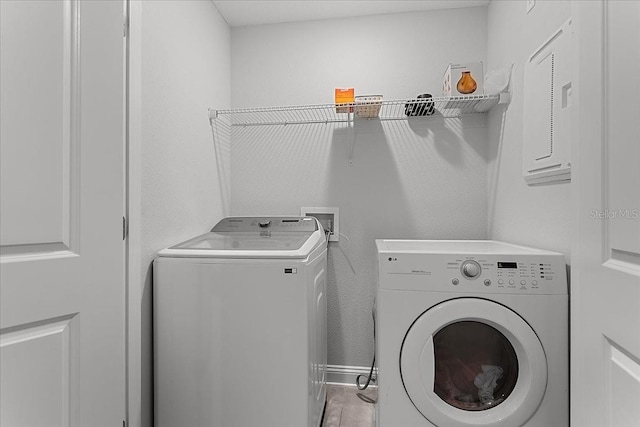 laundry area featuring washer and dryer and baseboards