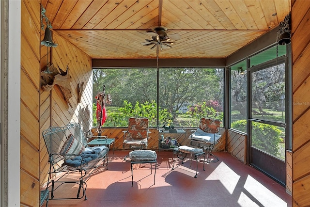 unfurnished sunroom with wooden ceiling and a ceiling fan