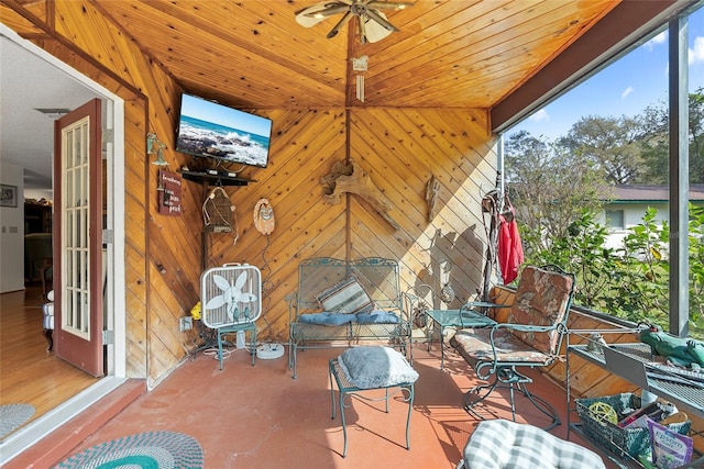 sunroom with wooden ceiling, a wealth of natural light, and ceiling fan