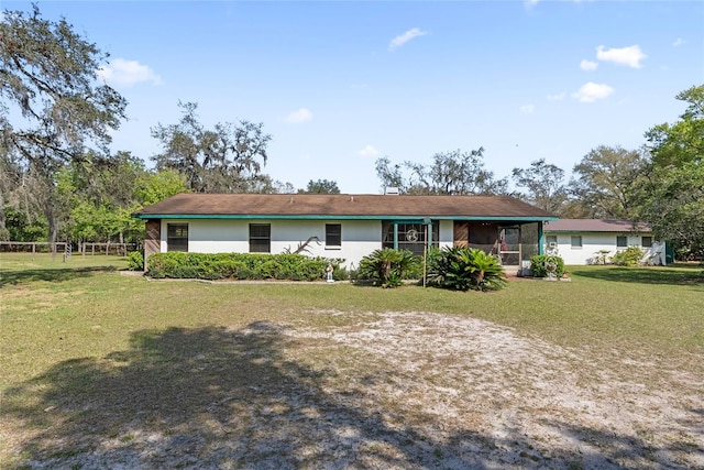 view of front of house with a front yard and fence