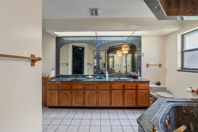 3634 Apfel Rd, Wesley Chapel, FL 33543 - bathroom featuring double vanity, tile patterned flooring, a tub to relax in, and a chandelier