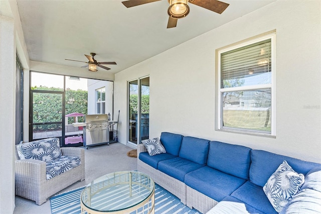 sunroom / solarium featuring ceiling fan