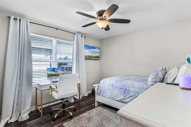 bedroom with a ceiling fan, wood finished floors, and a textured ceiling