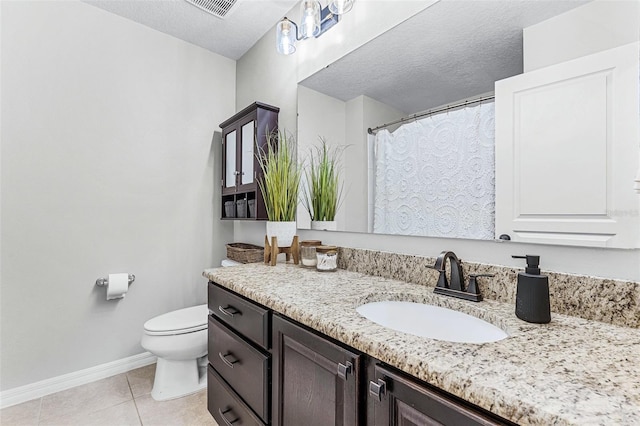 full bath with vanity, baseboards, a textured ceiling, tile patterned floors, and toilet