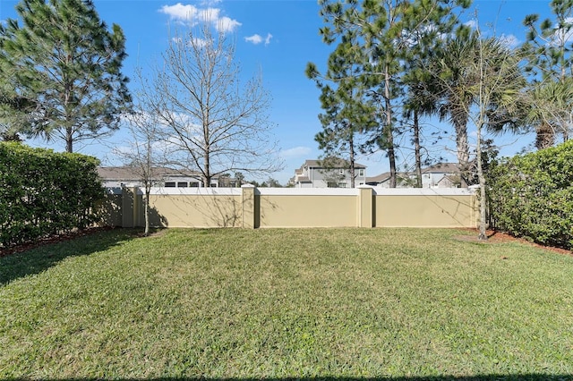 view of yard with a fenced backyard