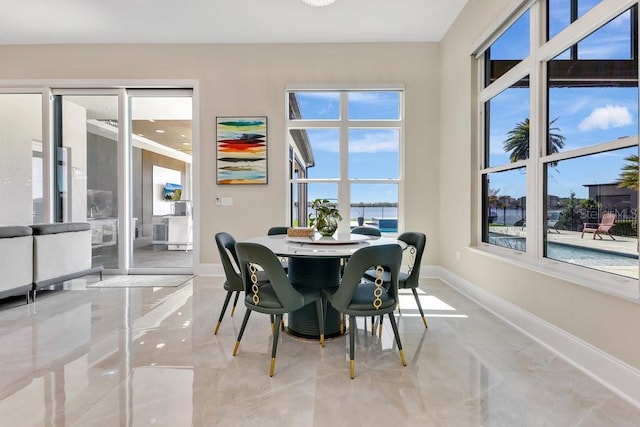 dining room featuring baseboards and marble finish floor