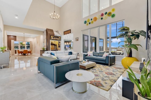 living room with marble finish floor and an inviting chandelier