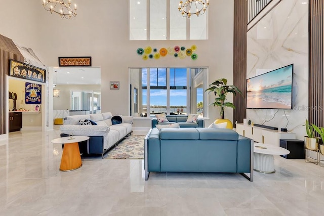 living area featuring a wealth of natural light, a notable chandelier, and marble finish floor