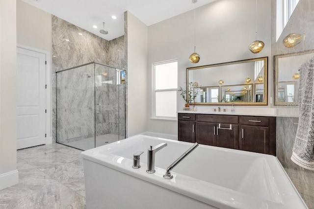 bathroom featuring vanity, a garden tub, a stall shower, and marble finish floor