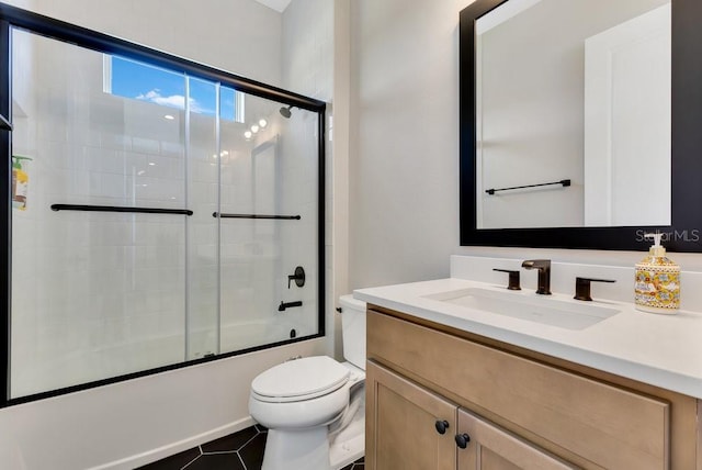 full bath featuring shower / bath combination with glass door, toilet, vanity, and tile patterned flooring