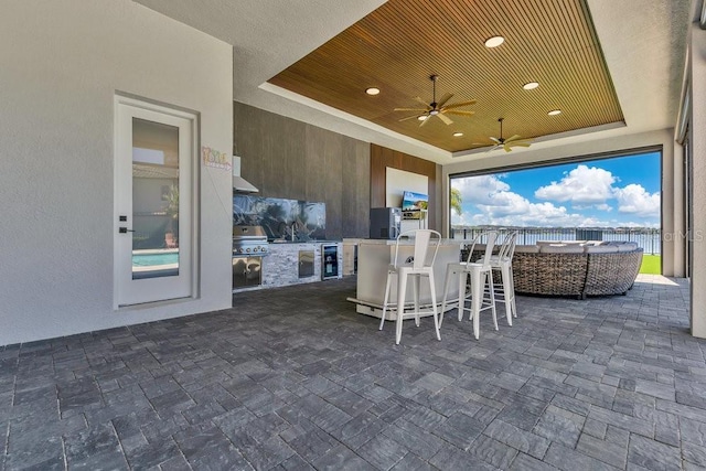 view of patio featuring area for grilling, grilling area, and ceiling fan