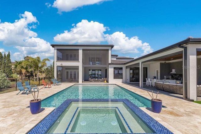 view of swimming pool featuring a patio, a pool with connected hot tub, and fence