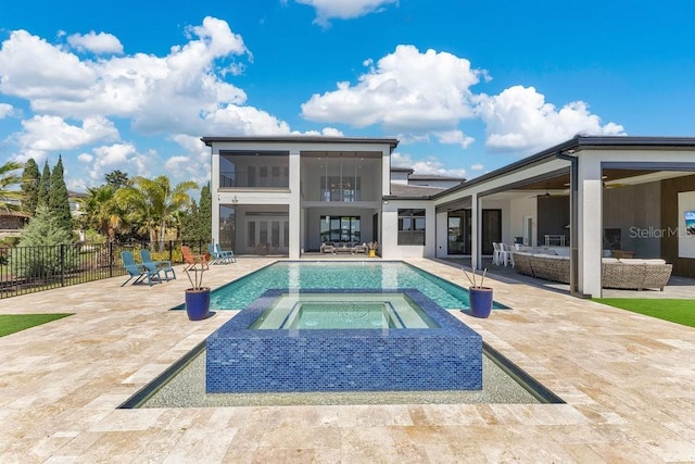 view of swimming pool featuring a fenced in pool, ceiling fan, fence, an in ground hot tub, and a patio