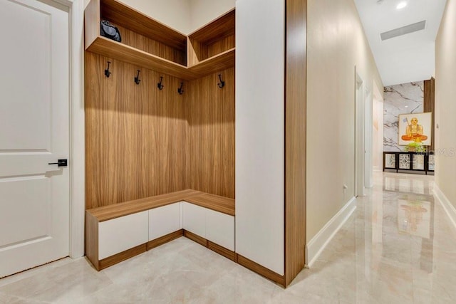 mudroom featuring visible vents, marble finish floor, and baseboards