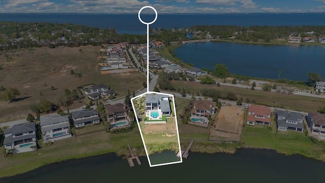 birds eye view of property featuring a water view and a residential view