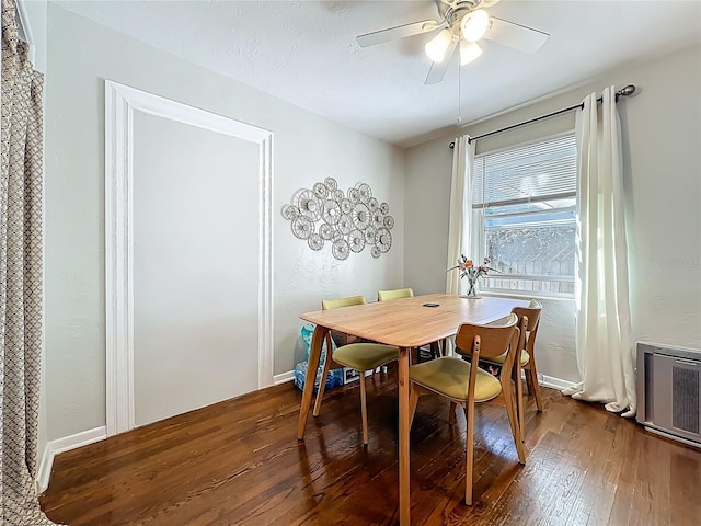 dining space featuring a textured ceiling, dark wood-type flooring, baseboards, and ceiling fan