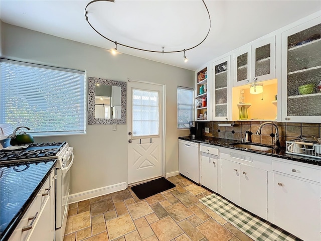 kitchen featuring a sink, white cabinetry, gas stove, white dishwasher, and decorative backsplash