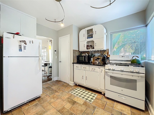 kitchen with dark countertops, tasteful backsplash, glass insert cabinets, white appliances, and white cabinetry