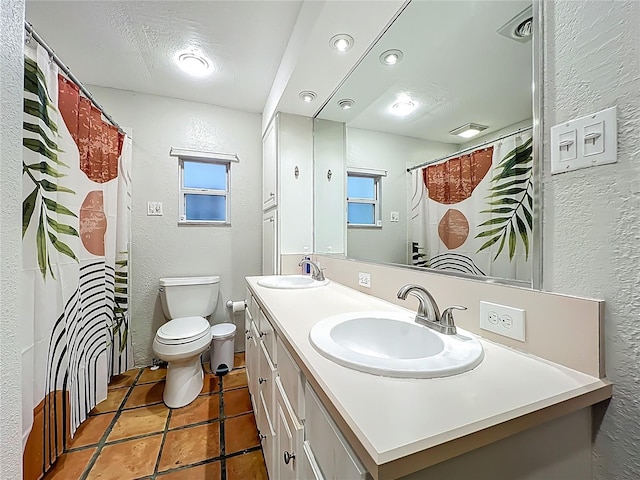 bathroom with toilet, a textured wall, and a sink