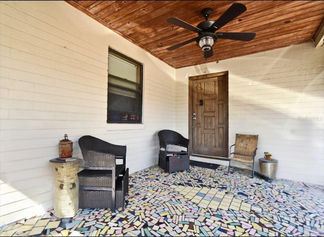 entrance to property with a patio area and ceiling fan