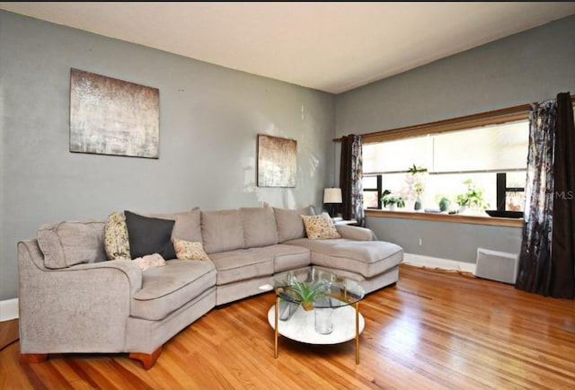 living room featuring baseboards and wood finished floors