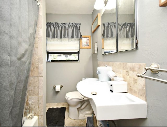 full bathroom with tile patterned flooring, toilet, and a sink