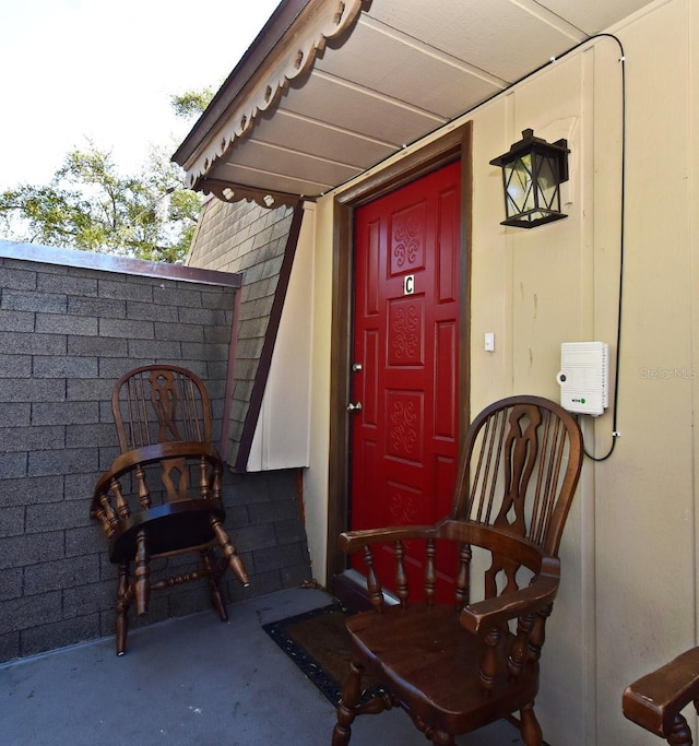 property entrance featuring a shingled roof