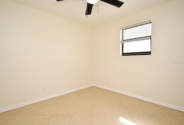 unfurnished room featuring baseboards, ceiling fan, and light tile patterned flooring