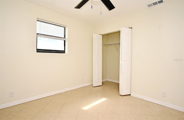 unfurnished bedroom with a closet, visible vents, baseboards, and light tile patterned floors