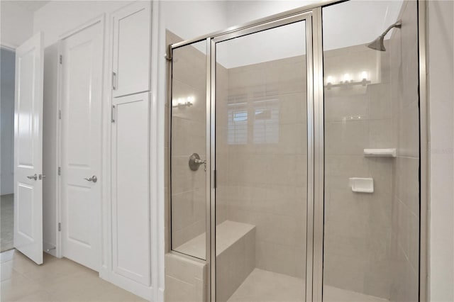 bathroom with tile patterned floors and a stall shower