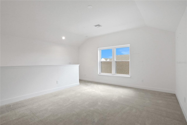 additional living space with visible vents, baseboards, recessed lighting, carpet flooring, and vaulted ceiling