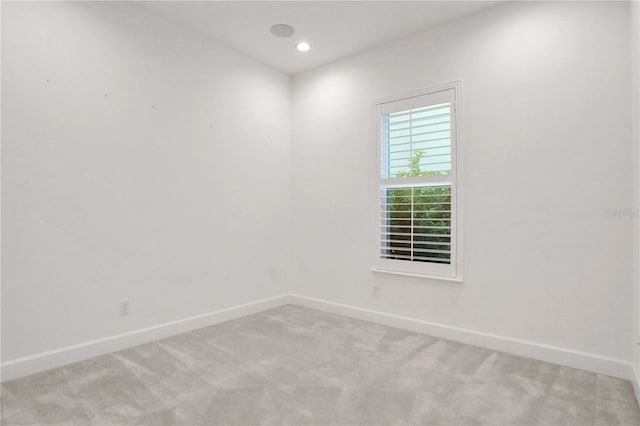 unfurnished room with baseboards, light carpet, and recessed lighting