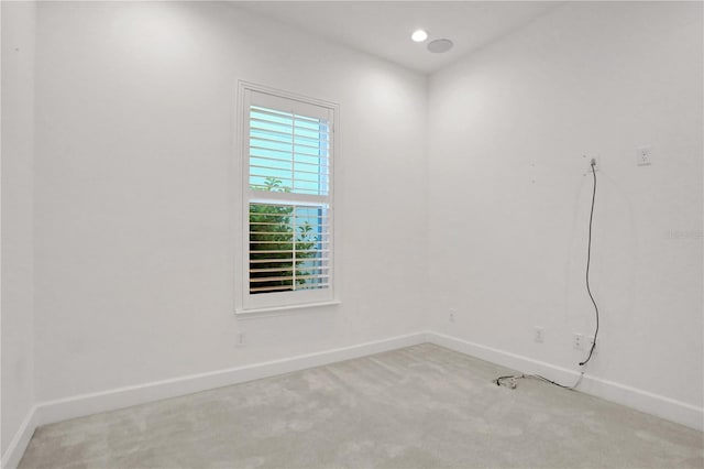 carpeted spare room with baseboards