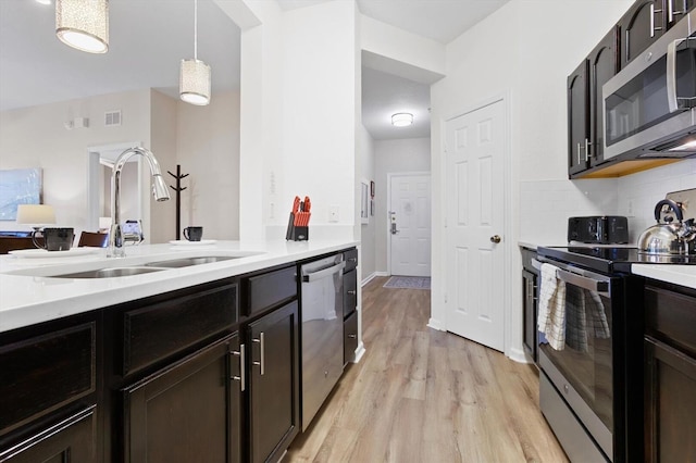 kitchen featuring light countertops, visible vents, appliances with stainless steel finishes, and a sink