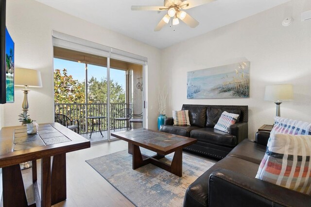 living area with ceiling fan and wood finished floors