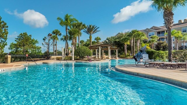 community pool featuring a patio, fence, and a pergola