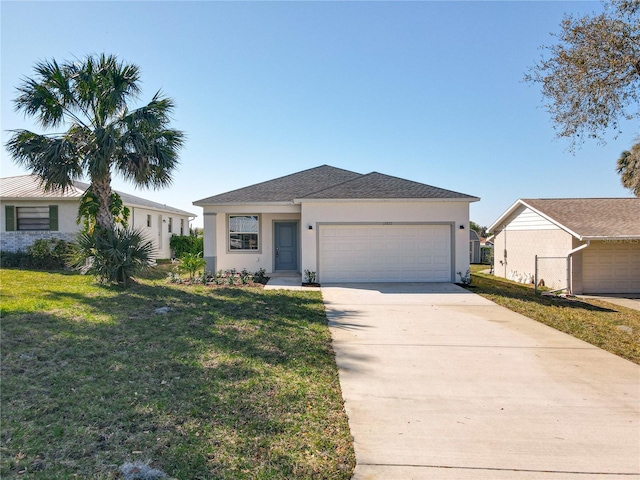 view of front of home with a front lawn, an attached garage, driveway, and stucco siding