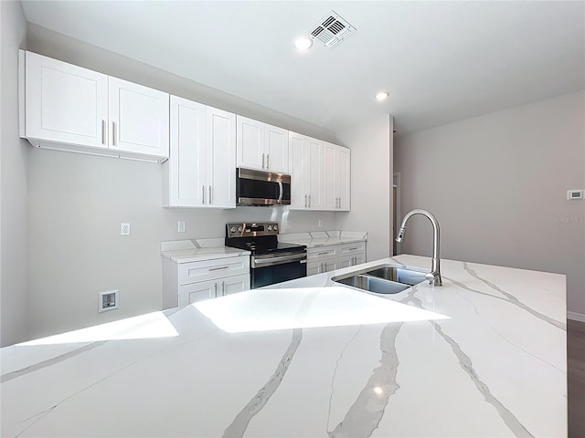 kitchen featuring visible vents, a sink, white cabinetry, recessed lighting, and appliances with stainless steel finishes