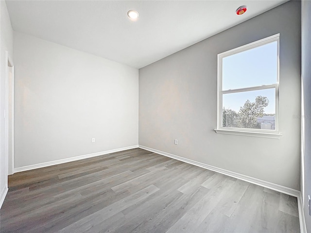 unfurnished room featuring wood finished floors and baseboards